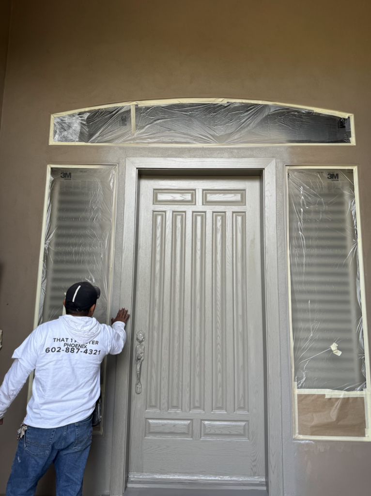 Painters in Fountain Hills in the process of painting a front door for their clients - That 1 Painter Phoenix
